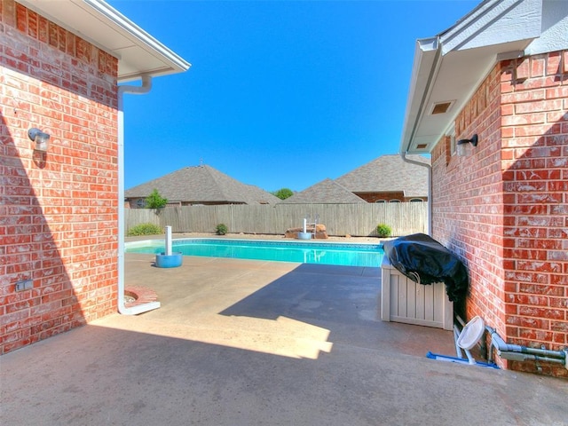 9333 SW 22nd St, Oklahoma City, OK 73128 - view of swimming pool with grilling area, a fenced backyard, a fenced in pool, and a patio