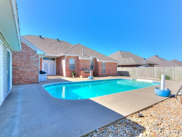 9333 SW 22nd St, Oklahoma City, OK 73128 - view of swimming pool featuring a fenced backyard, a patio, a fenced in pool, and french doors