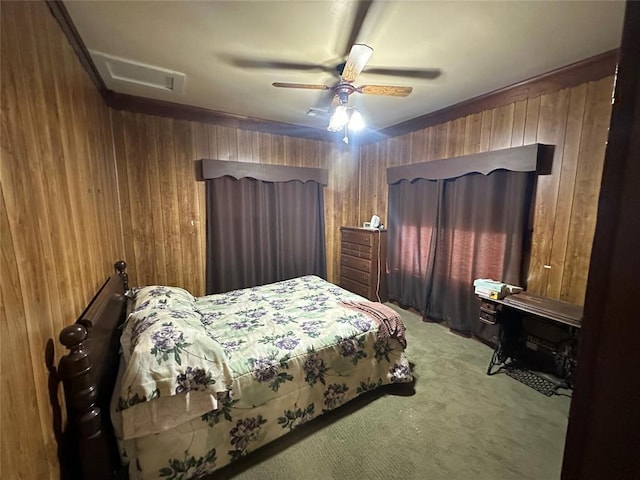 bedroom featuring light carpet, wooden walls, attic access, and a ceiling fan