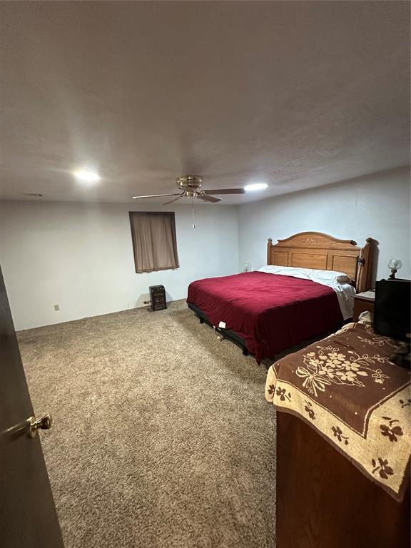 bedroom with a ceiling fan and carpet floors