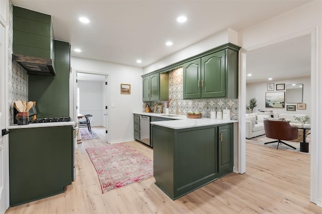 2501 NW 121st St, Oklahoma City, OK 73120 - kitchen featuring green cabinetry, light countertops, backsplash, a peninsula, and light wood-style flooring