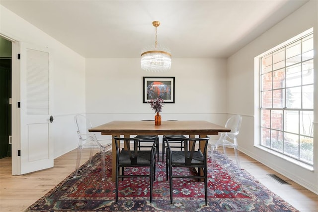 2501 NW 121st St, Oklahoma City, OK 73120 - dining room featuring a chandelier and light wood finished floors