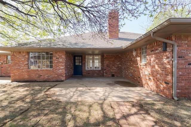 2501 NW 121st St, Oklahoma City, OK 73120 - back of house featuring a chimney and brick siding