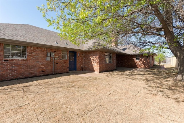 2501 NW 121st St, Oklahoma City, OK 73120 - back of house featuring brick siding and a shingled roof