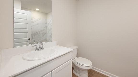 1209 E Stetson Ln, Mustang, OK 73064 - bathroom featuring baseboards, toilet, recessed lighting, vanity, and wood finished floors