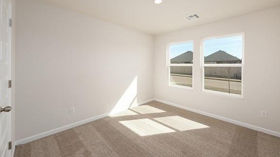 1209 E Stetson Ln, Mustang, OK 73064 - empty room featuring visible vents, baseboards, and carpet floors