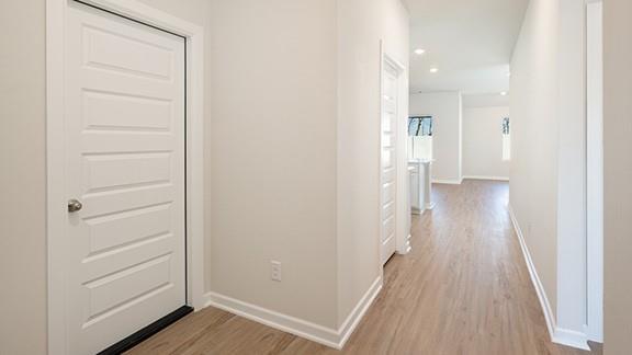 1209 E Stetson Ln, Mustang, OK 73064 - hallway with light wood finished floors, baseboards, and recessed lighting