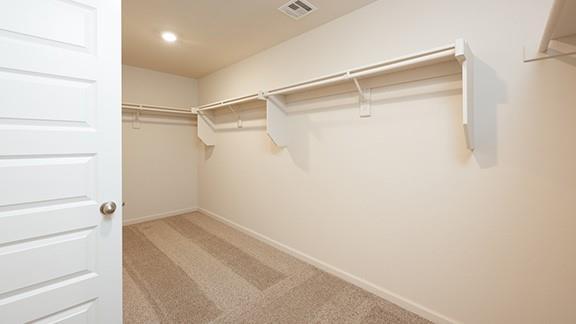 1209 E Stetson Ln, Mustang, OK 73064 - walk in closet with carpet flooring and visible vents
