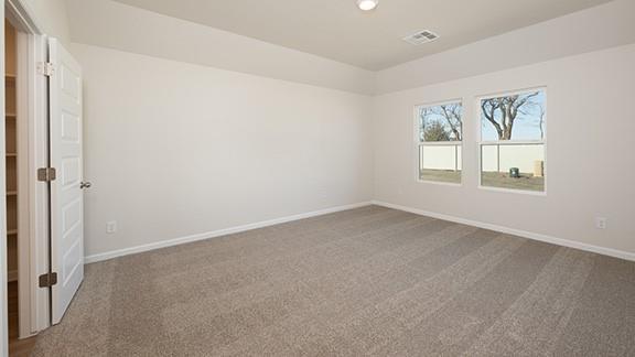 1209 E Stetson Ln, Mustang, OK 73064 - carpeted empty room with visible vents and baseboards
