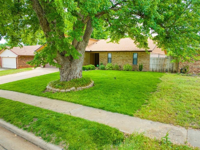 1520 NE 2nd St, Moore, OK 73160 - view of front of property with driveway, brick siding, a front lawn, and fence