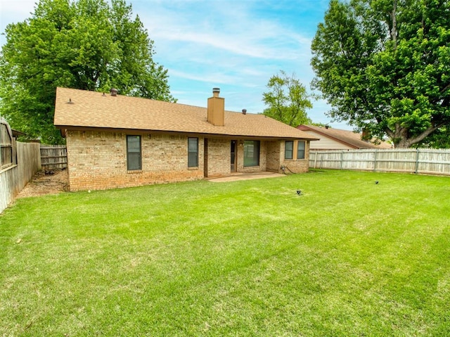 1520 NE 2nd St, Moore, OK 73160 - rear view of property featuring a fenced backyard, a patio, a yard, and a chimney