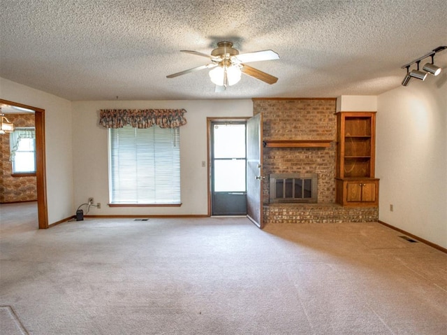 1520 NE 2nd St, Moore, OK 73160 - unfurnished living room featuring a textured ceiling, carpet floors, and a ceiling fan