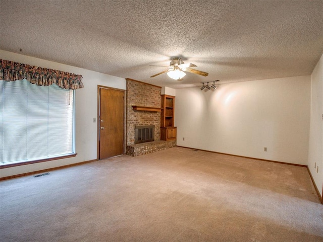 1520 NE 2nd St, Moore, OK 73160 - unfurnished living room featuring ceiling fan, light colored carpet, baseboards, and visible vents