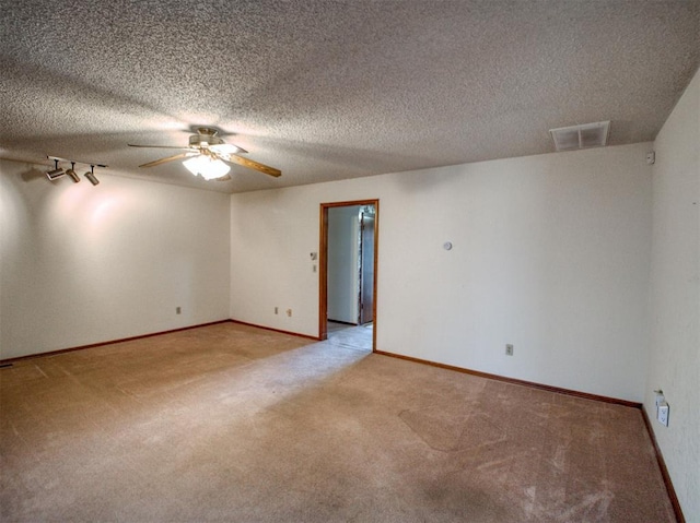 1520 NE 2nd St, Moore, OK 73160 - unfurnished room featuring light colored carpet, visible vents, baseboards, and a ceiling fan