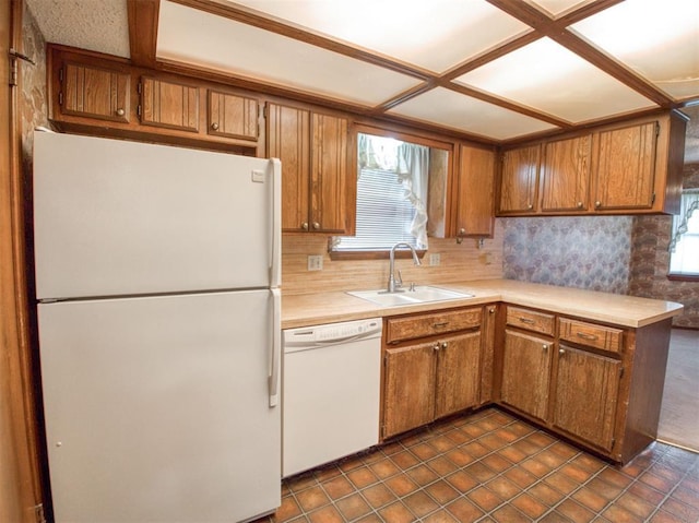 1520 NE 2nd St, Moore, OK 73160 - kitchen with brown cabinets, a sink, and white appliances