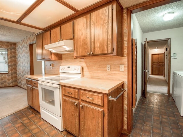 1520 NE 2nd St, Moore, OK 73160 - kitchen with a textured ceiling, separate washer and dryer, electric stove, and under cabinet range hood
