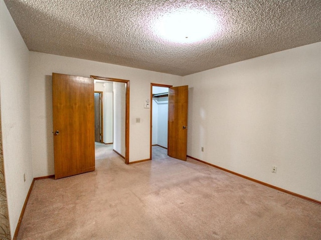 1520 NE 2nd St, Moore, OK 73160 - unfurnished bedroom featuring light carpet, a textured ceiling, a closet, and baseboards