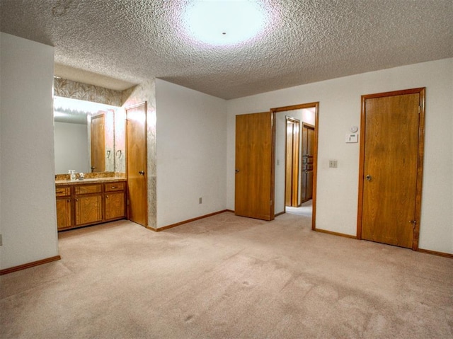 1520 NE 2nd St, Moore, OK 73160 - unfurnished bedroom featuring light carpet, a textured ceiling, and baseboards
