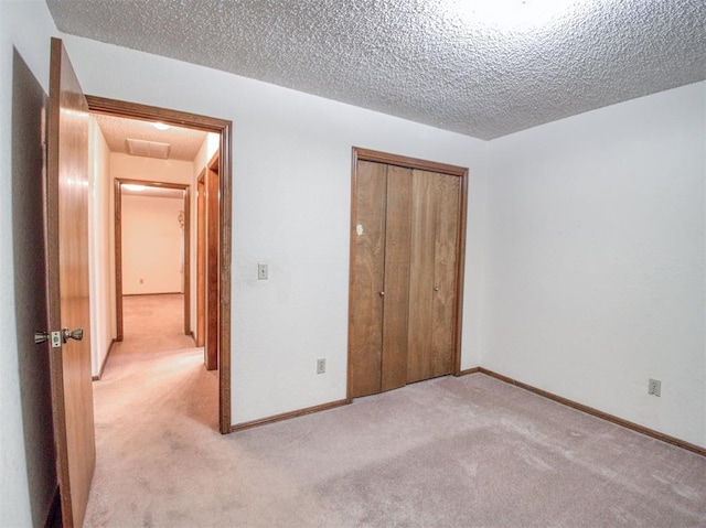 1520 NE 2nd St, Moore, OK 73160 - unfurnished bedroom featuring a textured ceiling, carpet flooring, a closet, and baseboards