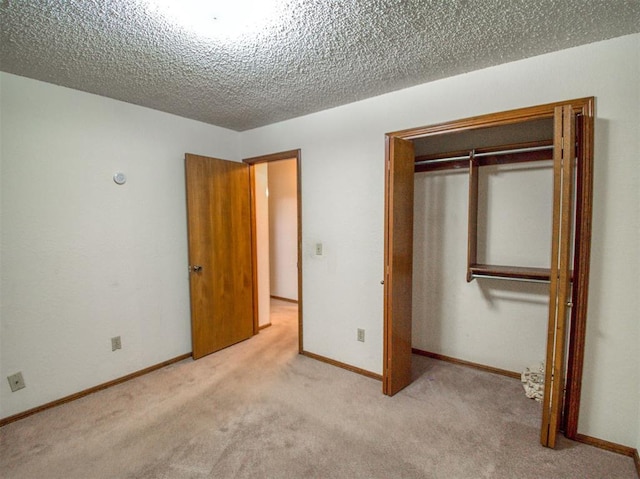 1520 NE 2nd St, Moore, OK 73160 - unfurnished bedroom with a textured ceiling, carpet flooring, a closet, and baseboards