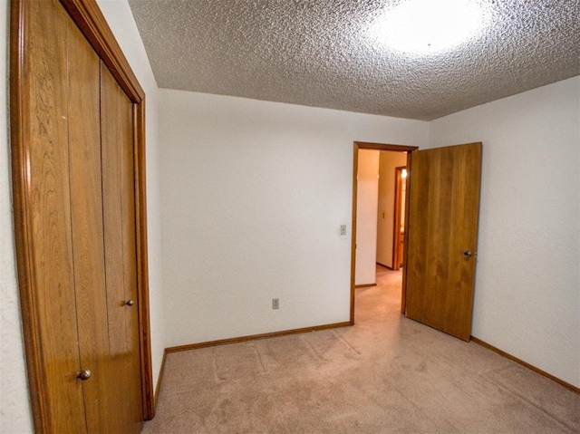 1520 NE 2nd St, Moore, OK 73160 - unfurnished bedroom with light colored carpet, a closet, a textured ceiling, and baseboards