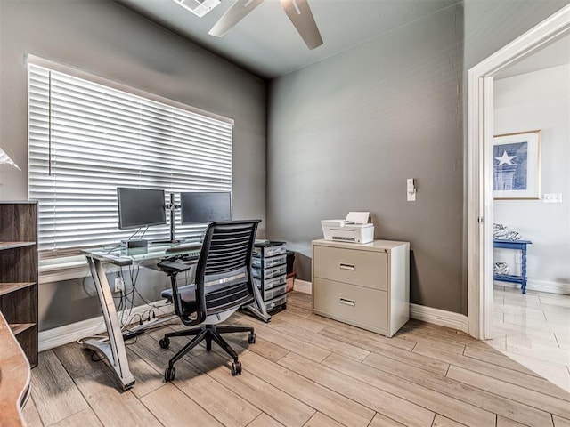 office with light wood-type flooring, ceiling fan, and baseboards
