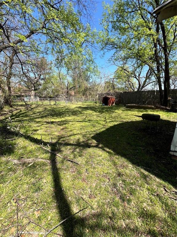 707 W Washington St, Tecumseh, OK 74873 - view of yard featuring an outbuilding, fence, and a storage unit