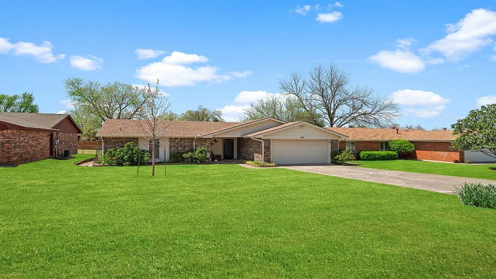 504 N 6th St, Noble, OK 73068 - single story home with driveway, a garage, and a front lawn