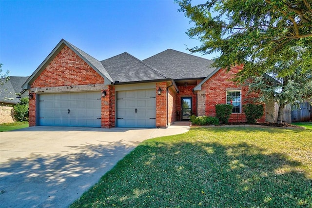 view of front of home featuring a garage, a front lawn, brick siding, a shingled roof, and concrete driveway