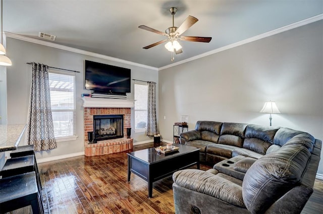 living area with crown molding, ceiling fan, visible vents, and dark wood-style flooring