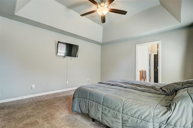 bedroom featuring baseboards, a raised ceiling, carpet flooring, and ceiling fan