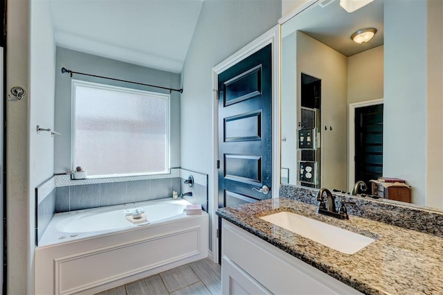 bathroom with vanity and a bath