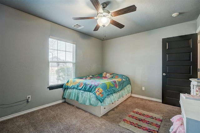 carpeted bedroom featuring ceiling fan, baseboards, and visible vents