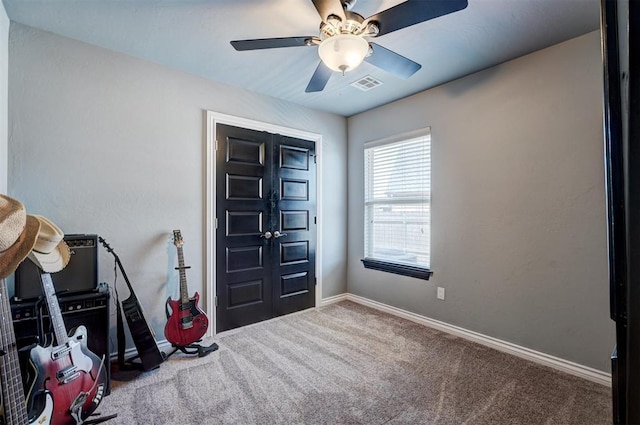 entrance foyer featuring carpet, visible vents, baseboards, and a ceiling fan