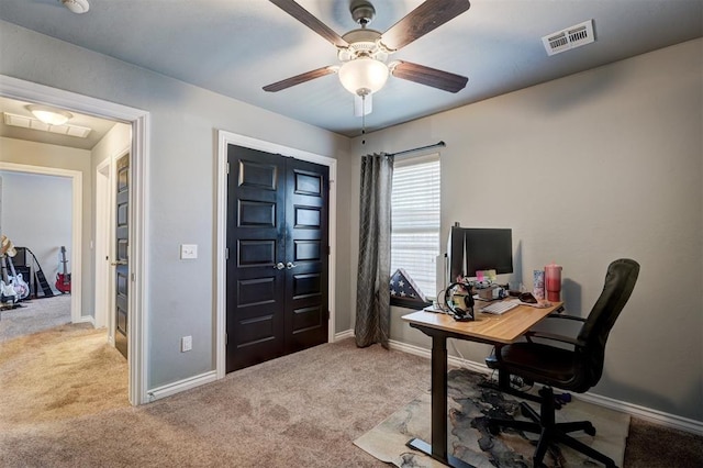 carpeted office featuring ceiling fan, baseboards, and visible vents