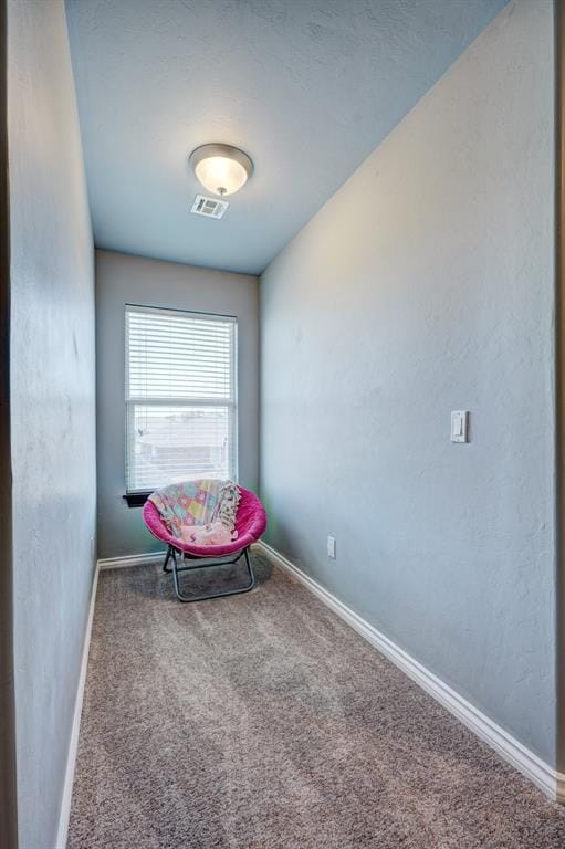 sitting room with carpet, visible vents, and baseboards