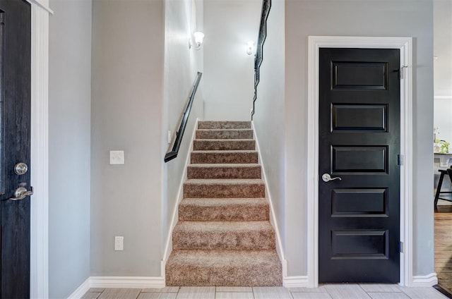 stairway featuring baseboards
