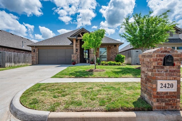 2420 NW 179th Ter, Edmond, OK 73012 - view of front of house featuring a front lawn, fence, brick siding, concrete driveway, and an attached garage