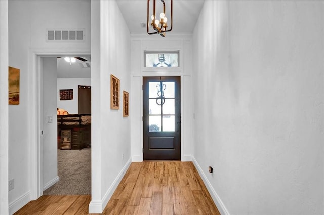 2420 NW 179th Ter, Edmond, OK 73012 - entryway featuring a notable chandelier, baseboards, visible vents, and light wood finished floors