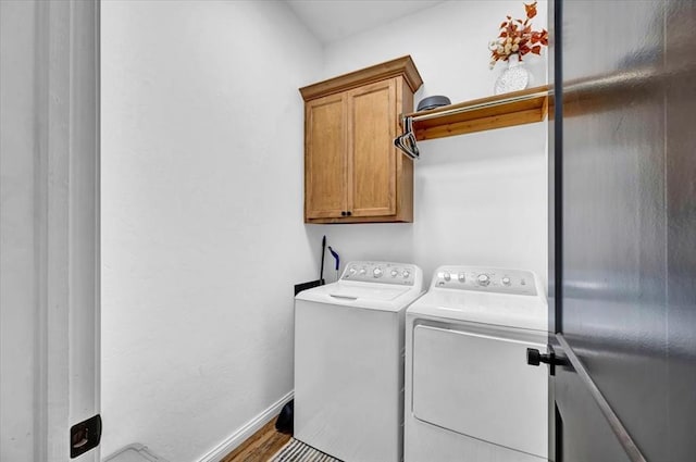 2420 NW 179th Ter, Edmond, OK 73012 - laundry room featuring baseboards, cabinet space, wood finished floors, and washing machine and clothes dryer