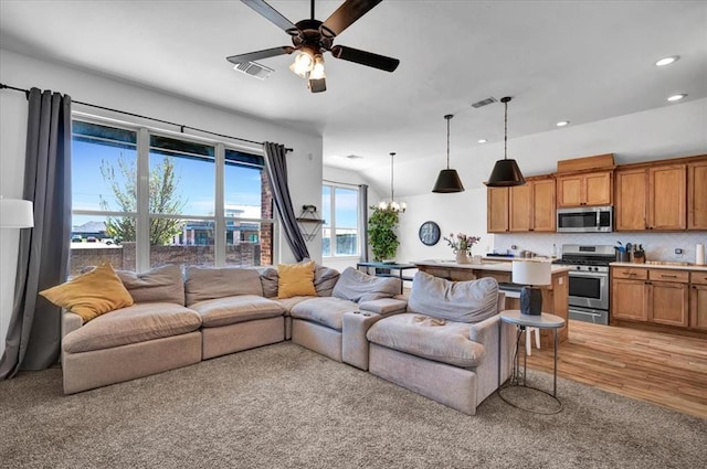 2420 NW 179th Ter, Edmond, OK 73012 - living room featuring visible vents, recessed lighting, light wood finished floors, and ceiling fan with notable chandelier
