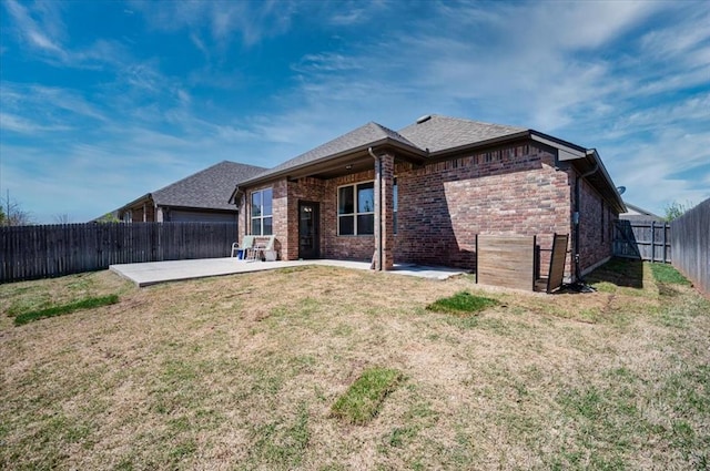 2420 NW 179th Ter, Edmond, OK 73012 - back of property featuring brick siding, a fenced backyard, a patio area, and a yard