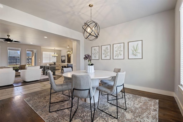 13120 Knight Island Dr, Oklahoma City, OK 73142 - dining space featuring dark wood-type flooring, baseboards, recessed lighting, and ceiling fan with notable chandelier