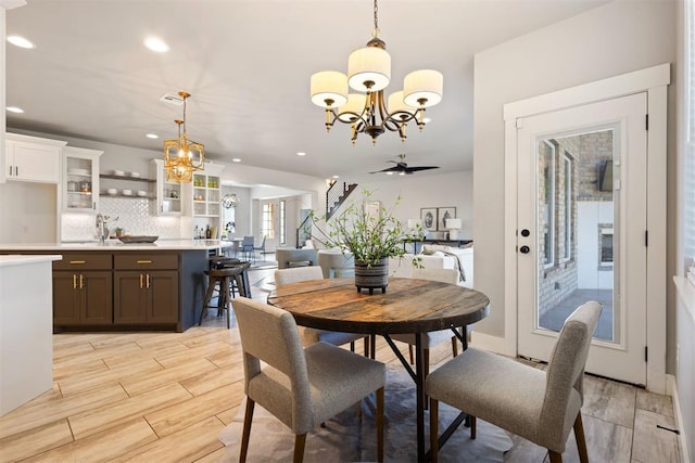 13120 Knight Island Dr, Oklahoma City, OK 73142 - dining space with ceiling fan with notable chandelier, wood tiled floor, and recessed lighting