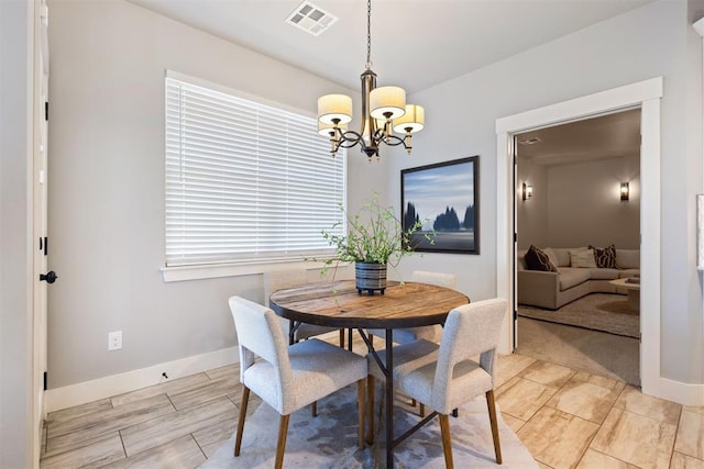 13120 Knight Island Dr, Oklahoma City, OK 73142 - dining space featuring a chandelier, visible vents, and baseboards