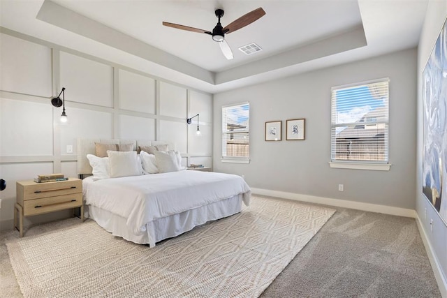 13120 Knight Island Dr, Oklahoma City, OK 73142 - bedroom with a tray ceiling, light colored carpet, a ceiling fan, visible vents, and baseboards