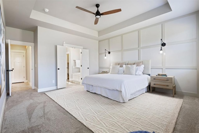 13120 Knight Island Dr, Oklahoma City, OK 73142 - bedroom with a tray ceiling, baseboards, carpet flooring, and ensuite bathroom