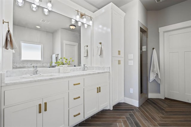 13120 Knight Island Dr, Oklahoma City, OK 73142 - full bathroom with baseboards, double vanity, a sink, and visible vents