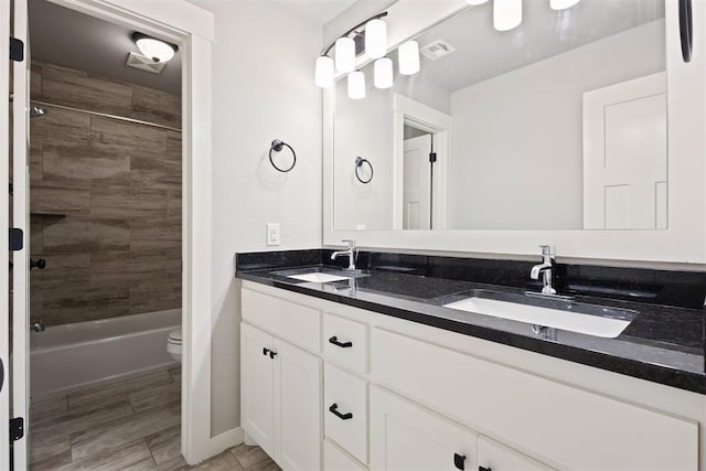 13120 Knight Island Dr, Oklahoma City, OK 73142 - bathroom featuring toilet, shower / tub combination, double vanity, and a sink