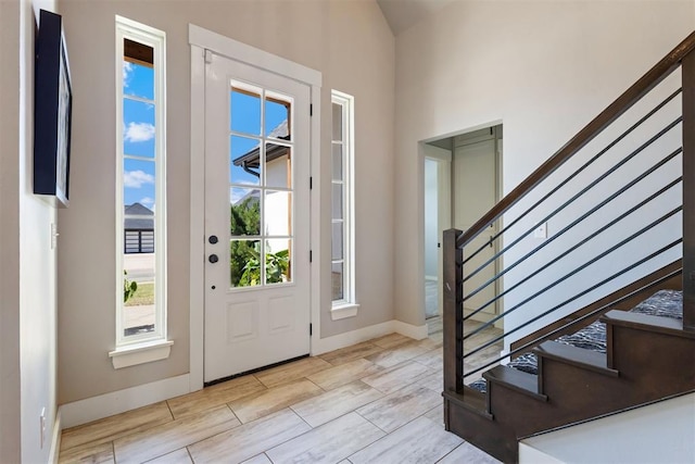 13120 Knight Island Dr, Oklahoma City, OK 73142 - entrance foyer featuring baseboards, wood tiled floor, and stairway
